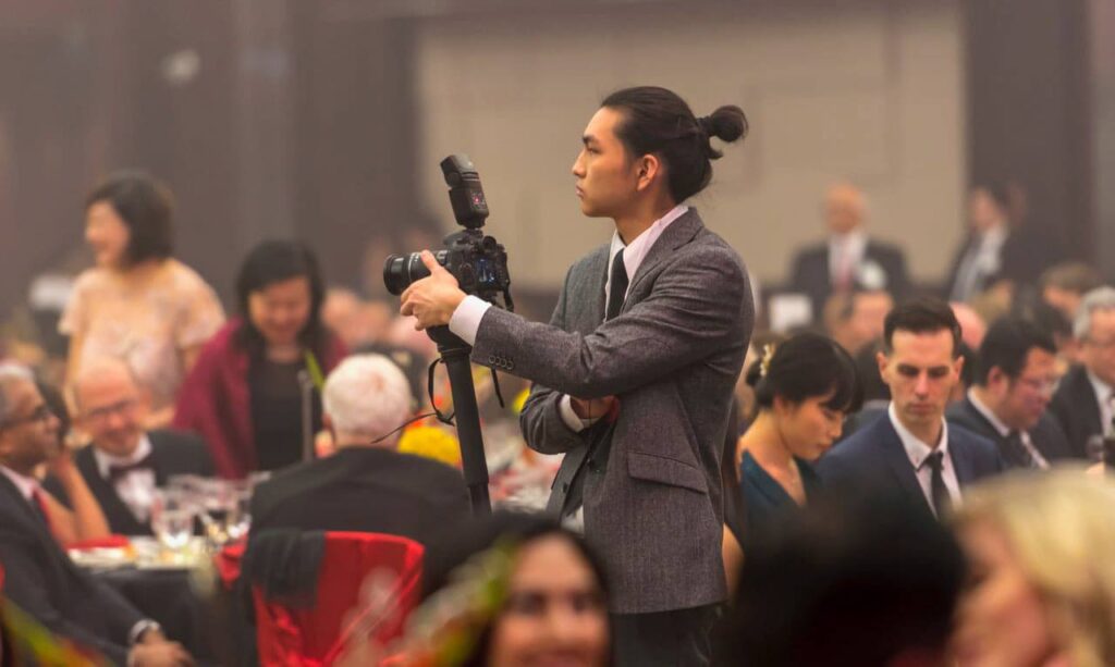 Photograph of Scott Luk while photographing an event